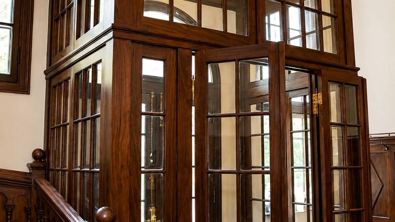 Glazed doors between two rooms, one leaf standing open