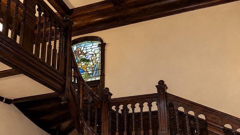 A stained-glass window above the staircase