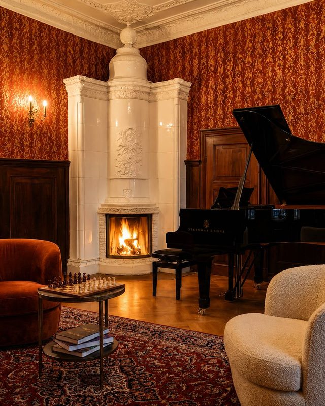 The tiled stove and the grand piano in the corner room